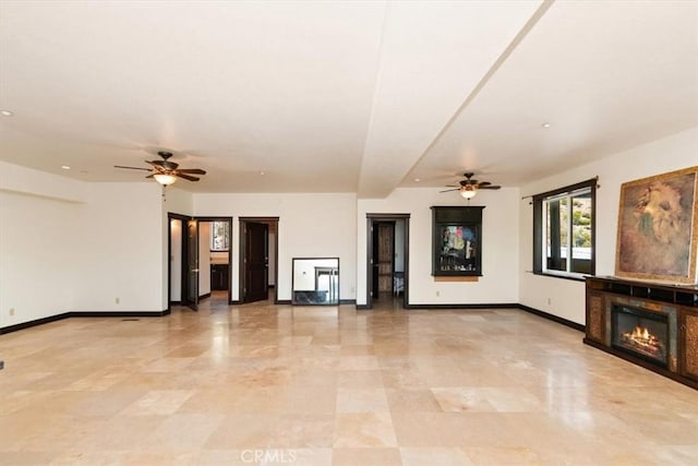 unfurnished living room with ceiling fan