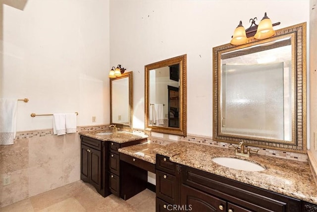 bathroom with vanity and tile walls