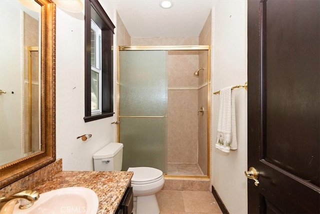 bathroom with walk in shower, vanity, toilet, and tile patterned flooring