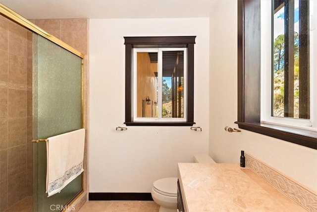 bathroom with vanity, an enclosed shower, tile patterned floors, and toilet