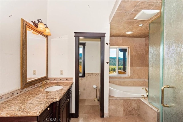 bathroom featuring tile patterned floors, vanity, separate shower and tub, and tile walls