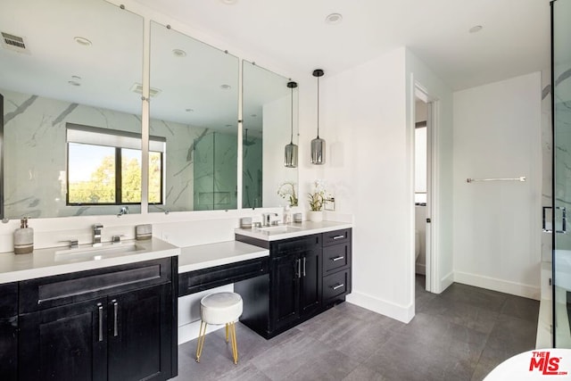 bathroom featuring vanity, a shower with door, and toilet