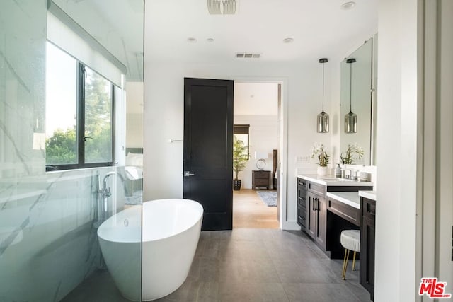 bathroom with vanity and a bathtub