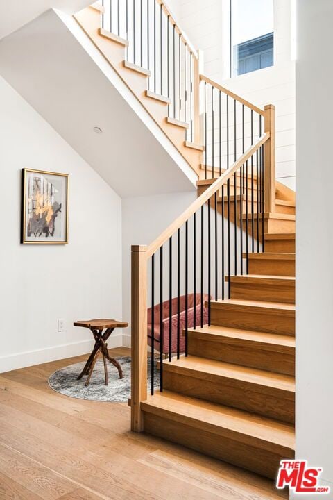 stairs with hardwood / wood-style floors