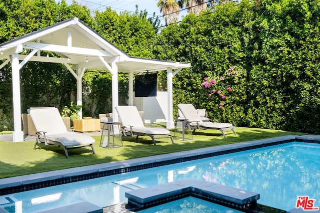 view of swimming pool with a gazebo and a lawn