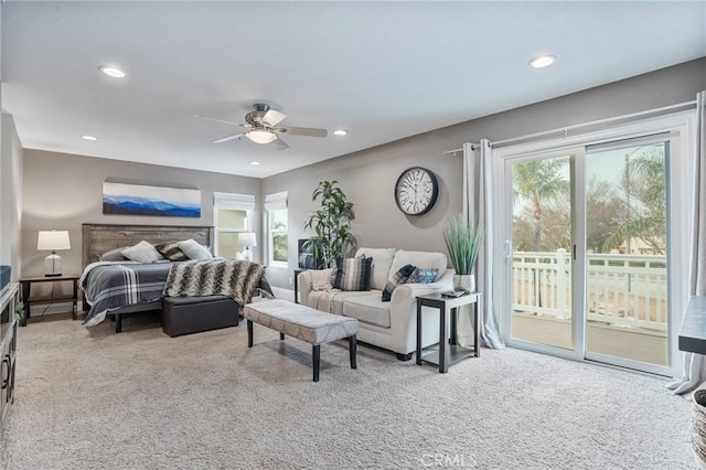 carpeted bedroom with multiple windows, access to outside, and ceiling fan