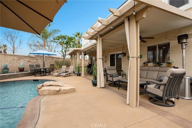 view of swimming pool featuring outdoor lounge area, ceiling fan, and a patio area