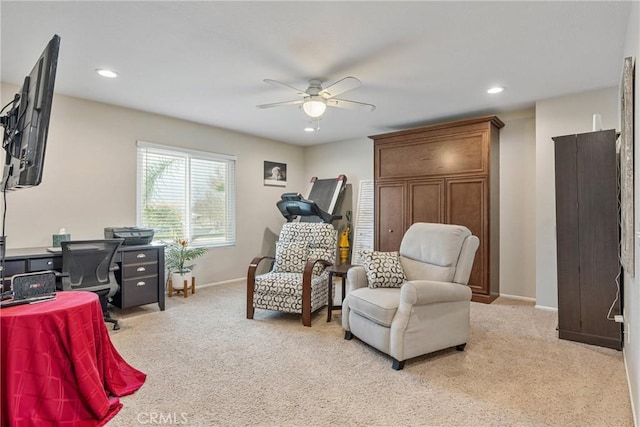 interior space featuring light carpet and ceiling fan