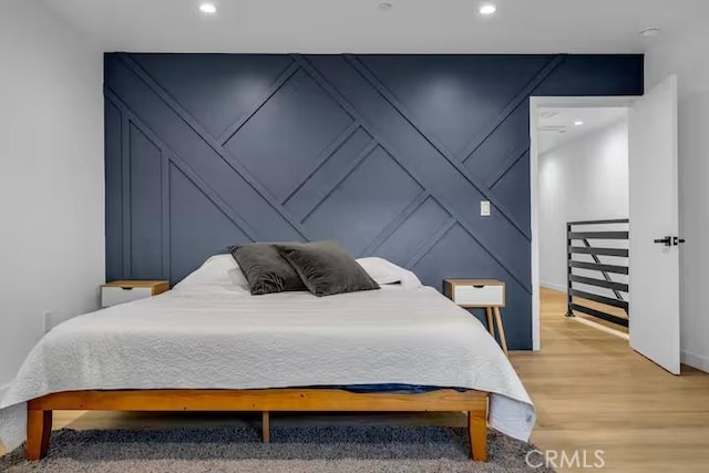 bedroom with hardwood / wood-style floors