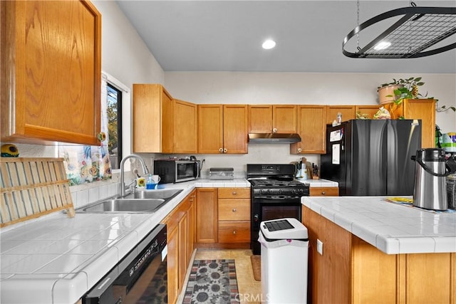 kitchen with sink, tile countertops, and black appliances