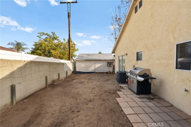 view of yard featuring central AC and a patio