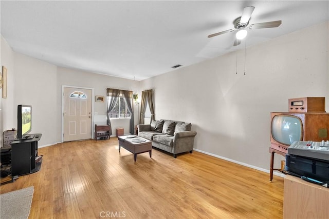 living room with ceiling fan and hardwood / wood-style floors