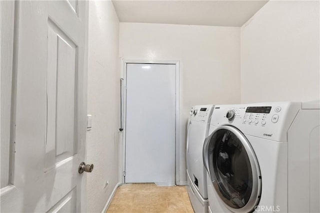 washroom featuring washer and dryer and light tile patterned floors