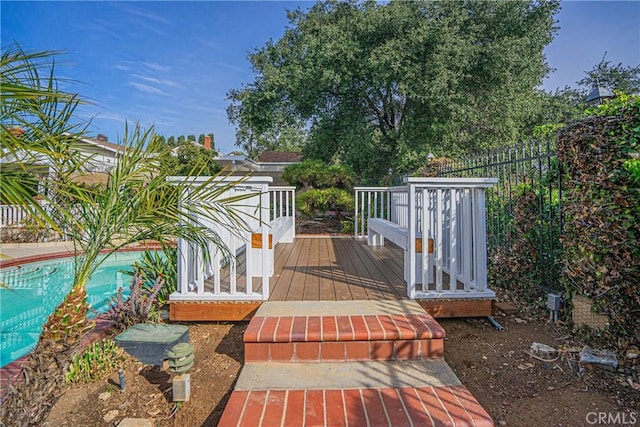 wooden terrace featuring a fenced in pool