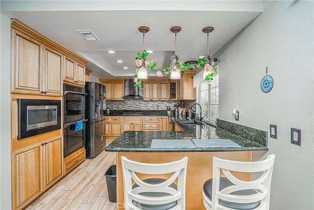 kitchen featuring sink, backsplash, stainless steel appliances, kitchen peninsula, and wall chimney exhaust hood