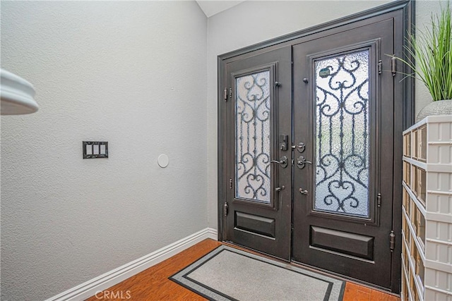 entrance foyer with wood-type flooring and french doors