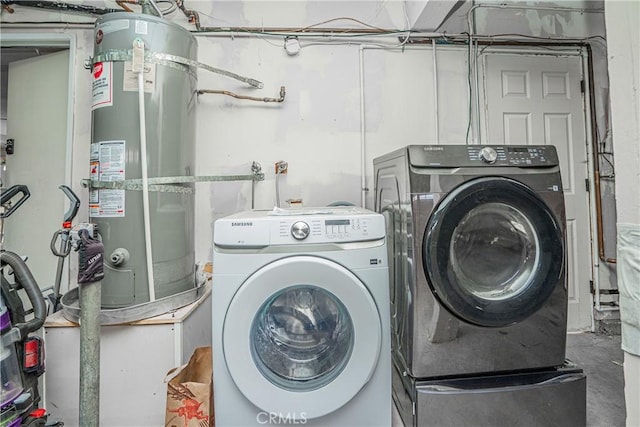 laundry room featuring independent washer and dryer and strapped water heater