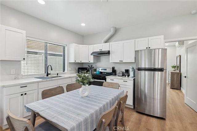 kitchen featuring sink, light hardwood / wood-style floors, white cabinets, and appliances with stainless steel finishes