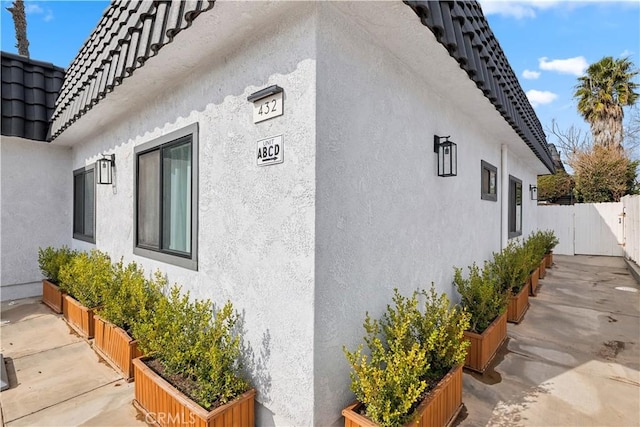 view of property exterior with a patio area