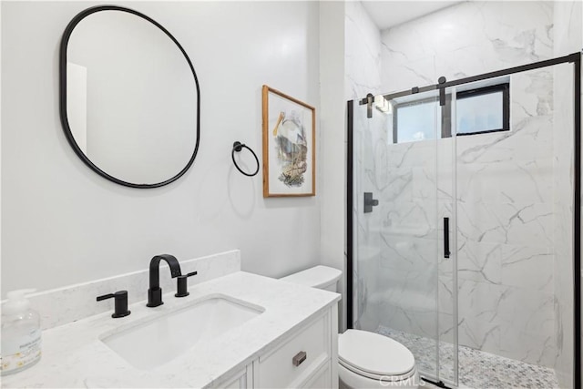 bathroom with vanity, toilet, and walk in shower