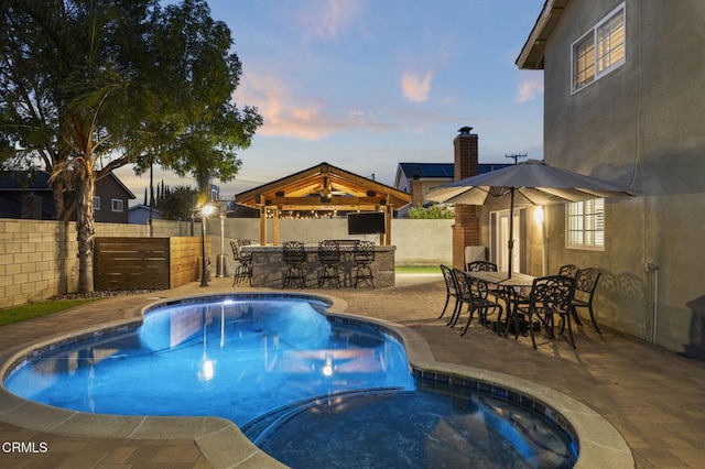 view of pool with a gazebo, an outdoor bar, a patio area, and a jacuzzi