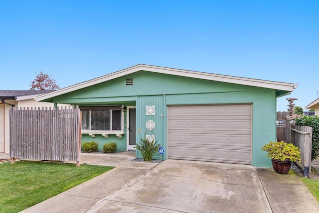 single story home featuring a garage and a front lawn