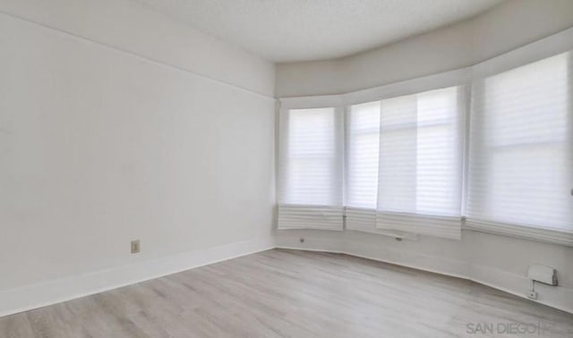 spare room with light hardwood / wood-style floors