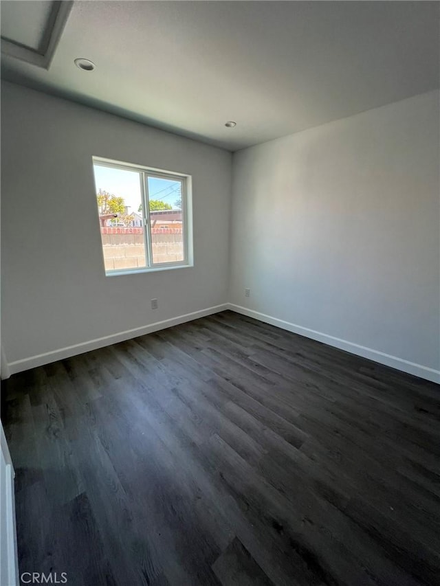 unfurnished room featuring dark wood-type flooring