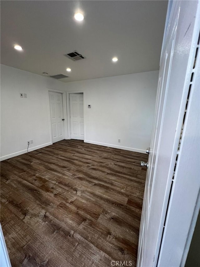 empty room featuring dark hardwood / wood-style flooring