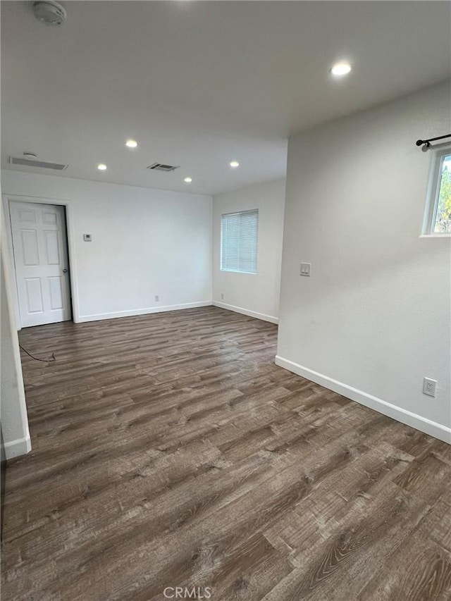 empty room with dark hardwood / wood-style flooring