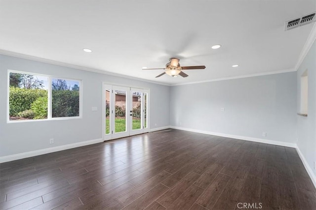 empty room featuring dark hardwood / wood-style flooring, ornamental molding, french doors, and ceiling fan