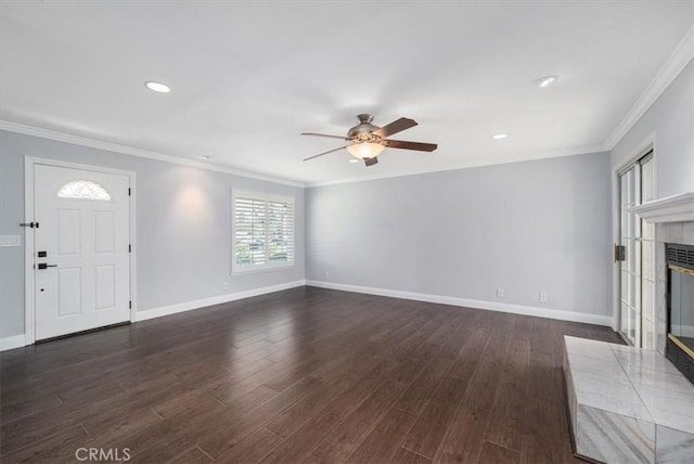 unfurnished living room featuring dark wood-type flooring, ornamental molding, and a tiled fireplace