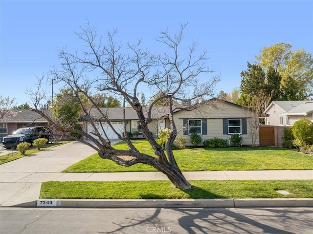 view of front of home with a garage and a front lawn