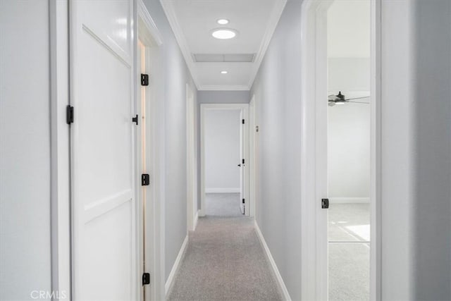 corridor with light carpet and crown molding