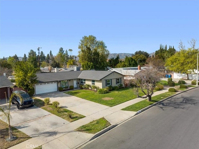 ranch-style home featuring a garage and a front lawn