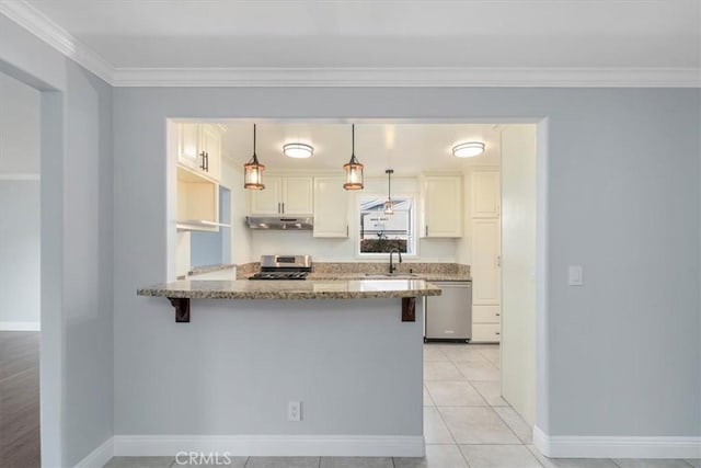 kitchen with sink, appliances with stainless steel finishes, light stone counters, decorative light fixtures, and kitchen peninsula