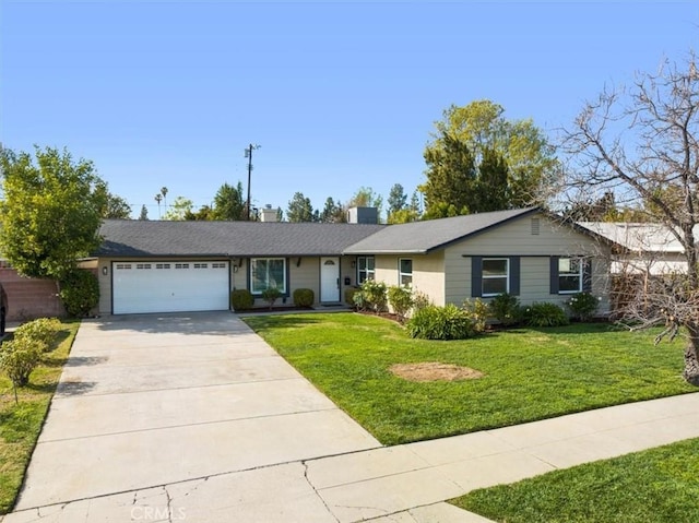 single story home featuring a garage and a front lawn