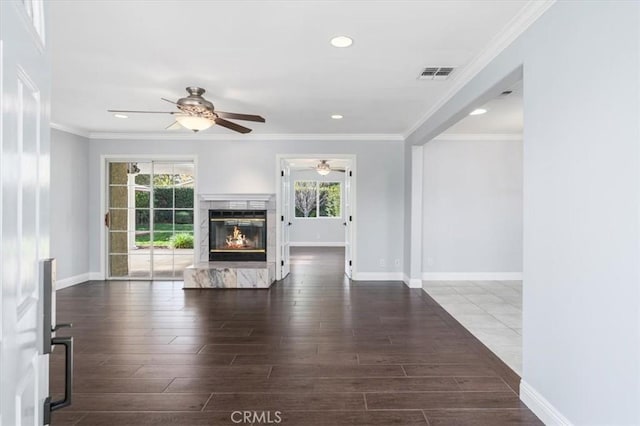 unfurnished living room with ornamental molding, ceiling fan, and dark hardwood / wood-style flooring