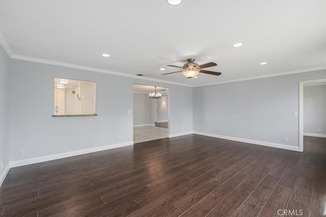 spare room with ornamental molding, dark wood-type flooring, and ceiling fan with notable chandelier