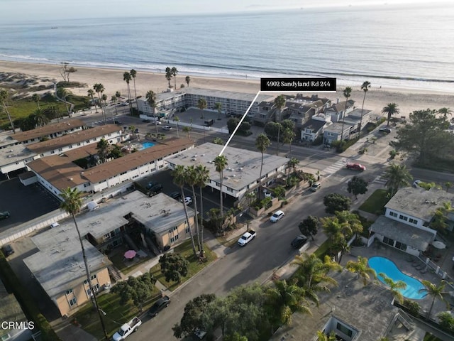 birds eye view of property featuring a view of the beach and a water view