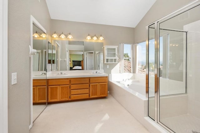 bathroom featuring vanity, separate shower and tub, and vaulted ceiling