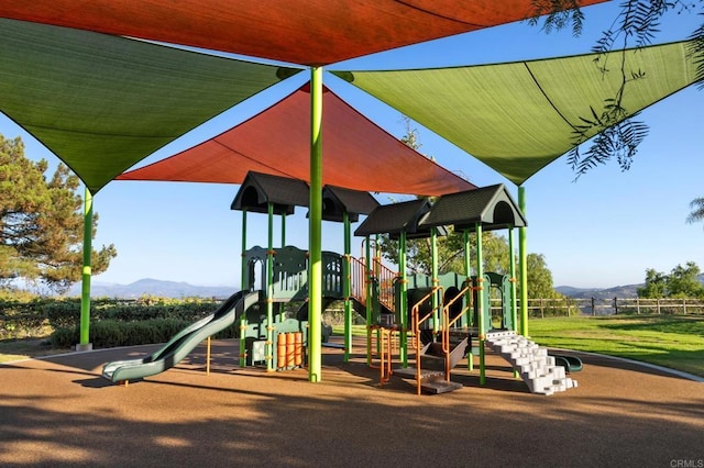 view of jungle gym with a mountain view