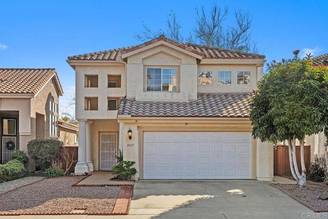 mediterranean / spanish-style home with a garage