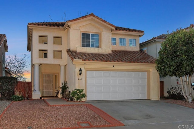 mediterranean / spanish home with a garage