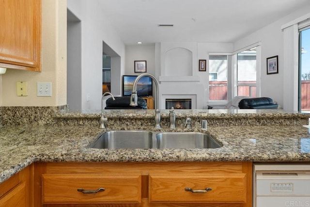 kitchen with light stone countertops and sink