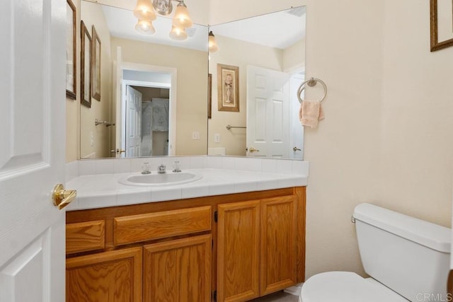 bathroom with visible vents, vanity, and toilet