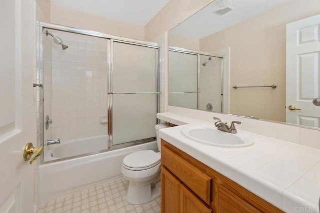 bathroom with enclosed tub / shower combo, toilet, visible vents, vanity, and tile patterned floors