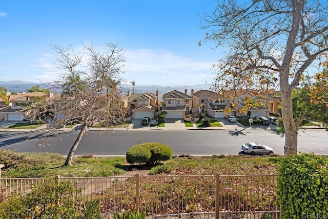 view of road featuring a residential view, curbs, and sidewalks