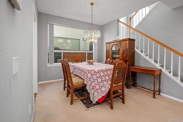 dining space featuring light carpet, stairway, and baseboards