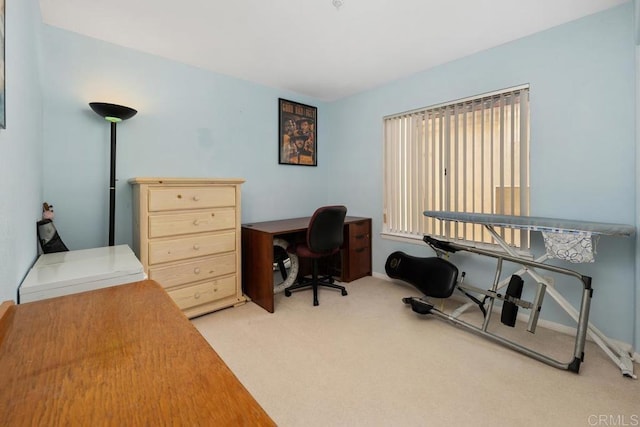 home office with light colored carpet and baseboards